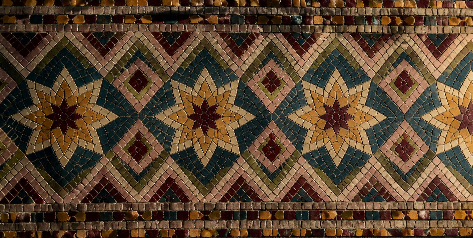 Mosaic composition of organic curves in earthy glazed tiles
